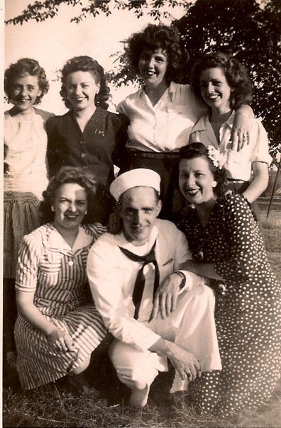 This is the day Norm Ouellette came home. His wife Mary clings to his arm while he's surrounded by his sisters, Pat, Bernie, Toni, Marie and their tall friend Dot. Detroit, 1944.
